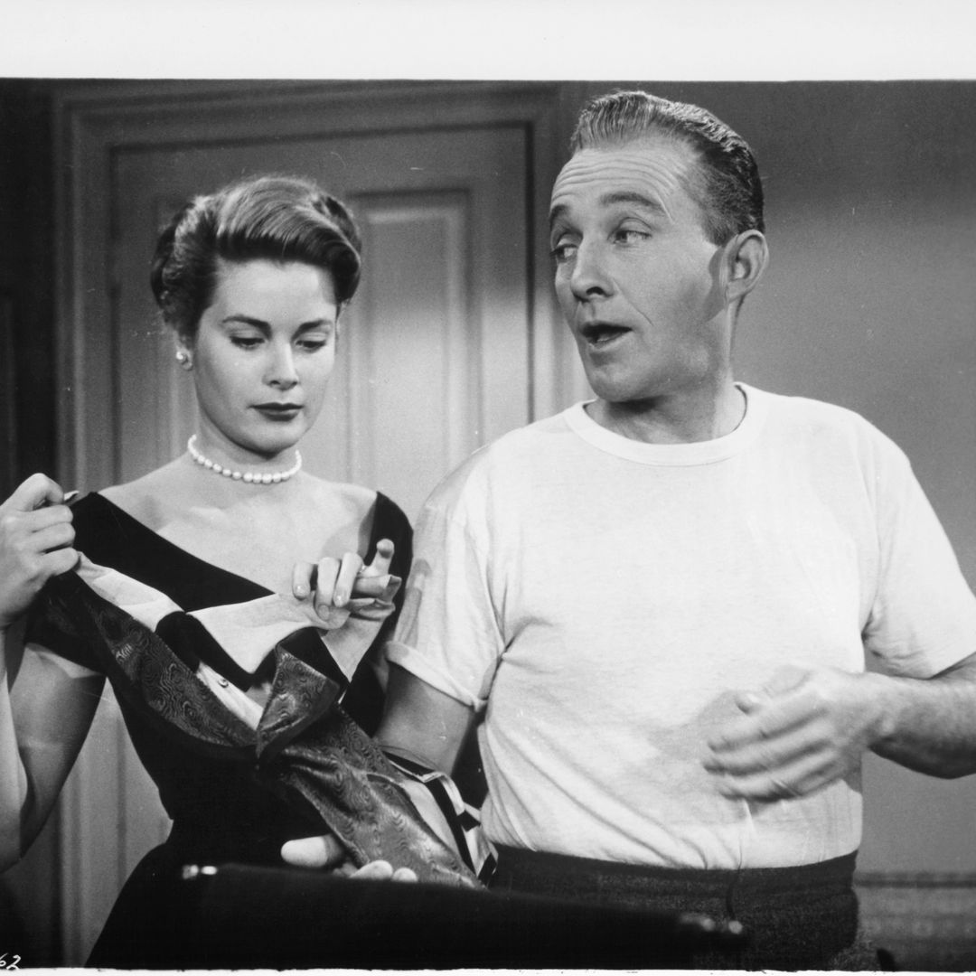 Grace Kelly pulling at a piece of clothing as Bing Crosby stands next to her in a scene from the film 'The Country Girl', 1954.