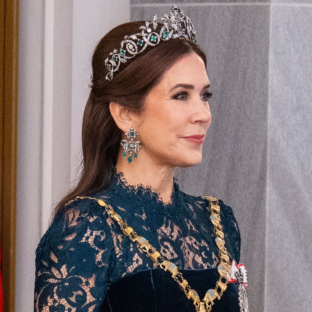 Queen Mary is a vision in glittering emerald tiara and sheer lace gown