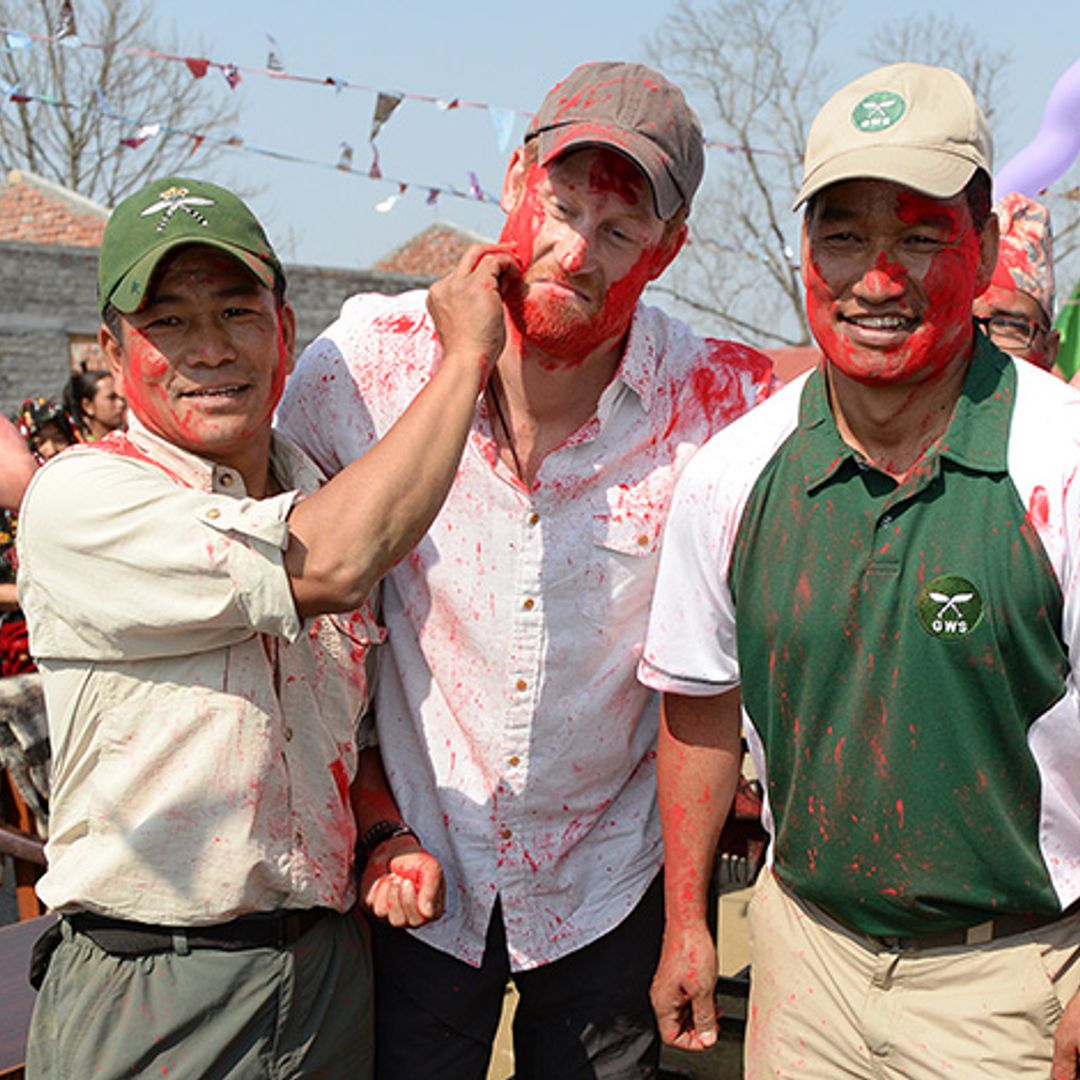 Prince Harry gives as good as he gets in traditional paint fight