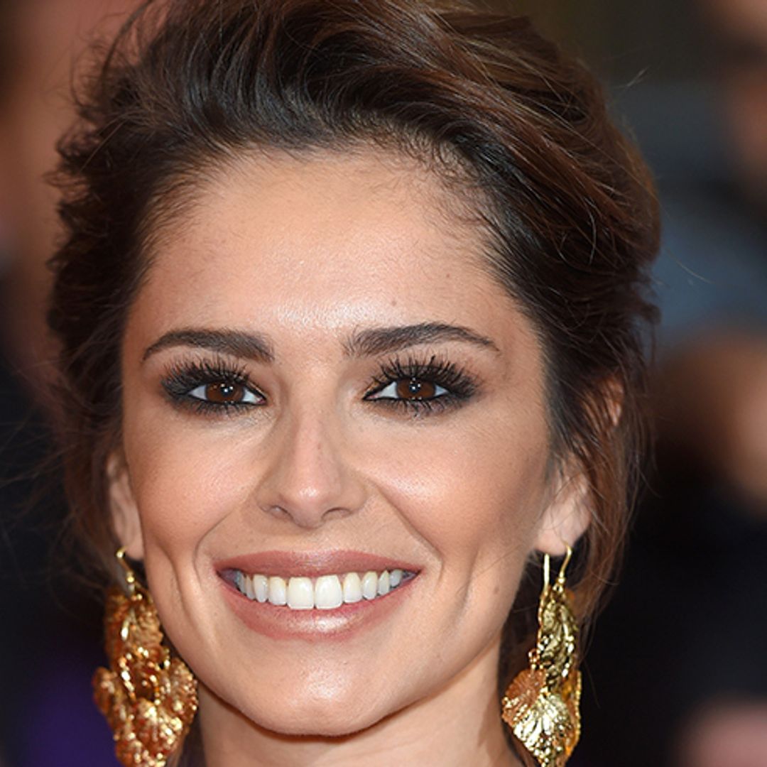 Cheryl makes sure to keep son Bear close to her in the sweetest way