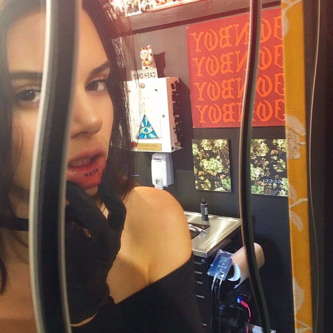 Kendall Jenner showing off her tattoo on the inside of her lip 