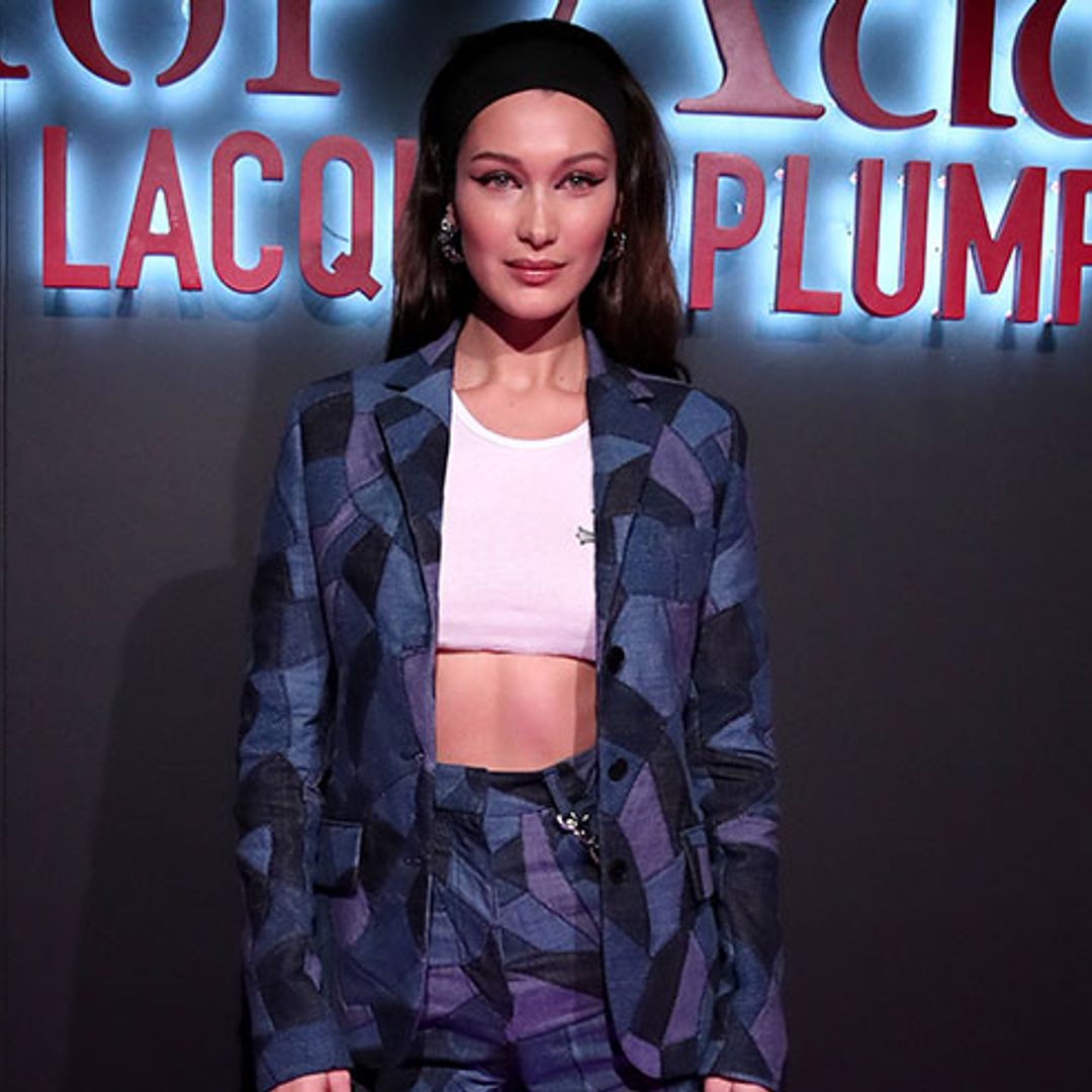 Bella Hadid shows off her killer abs in a denim patchwork suit