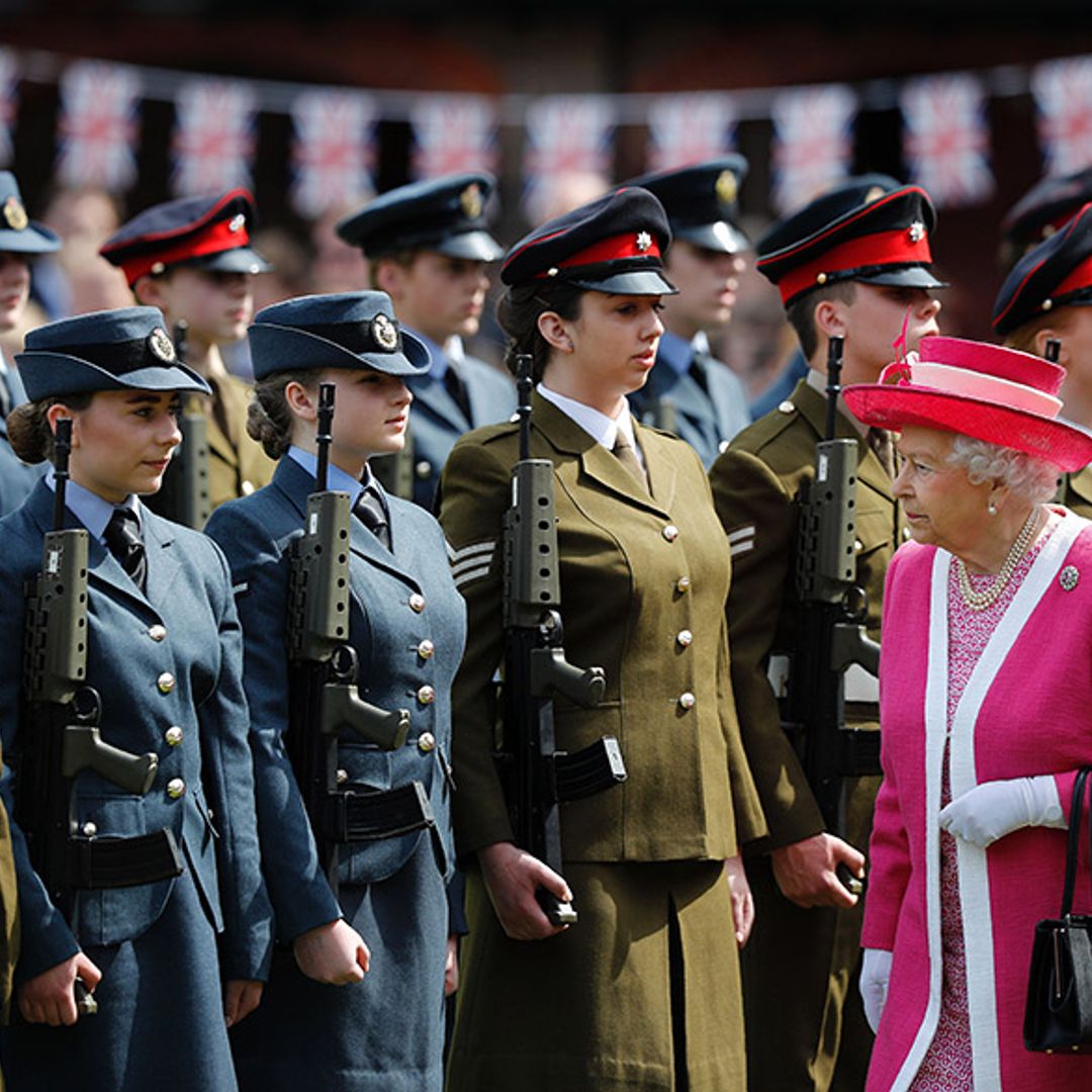 The Queen is resplendent in pink as she makes school visit