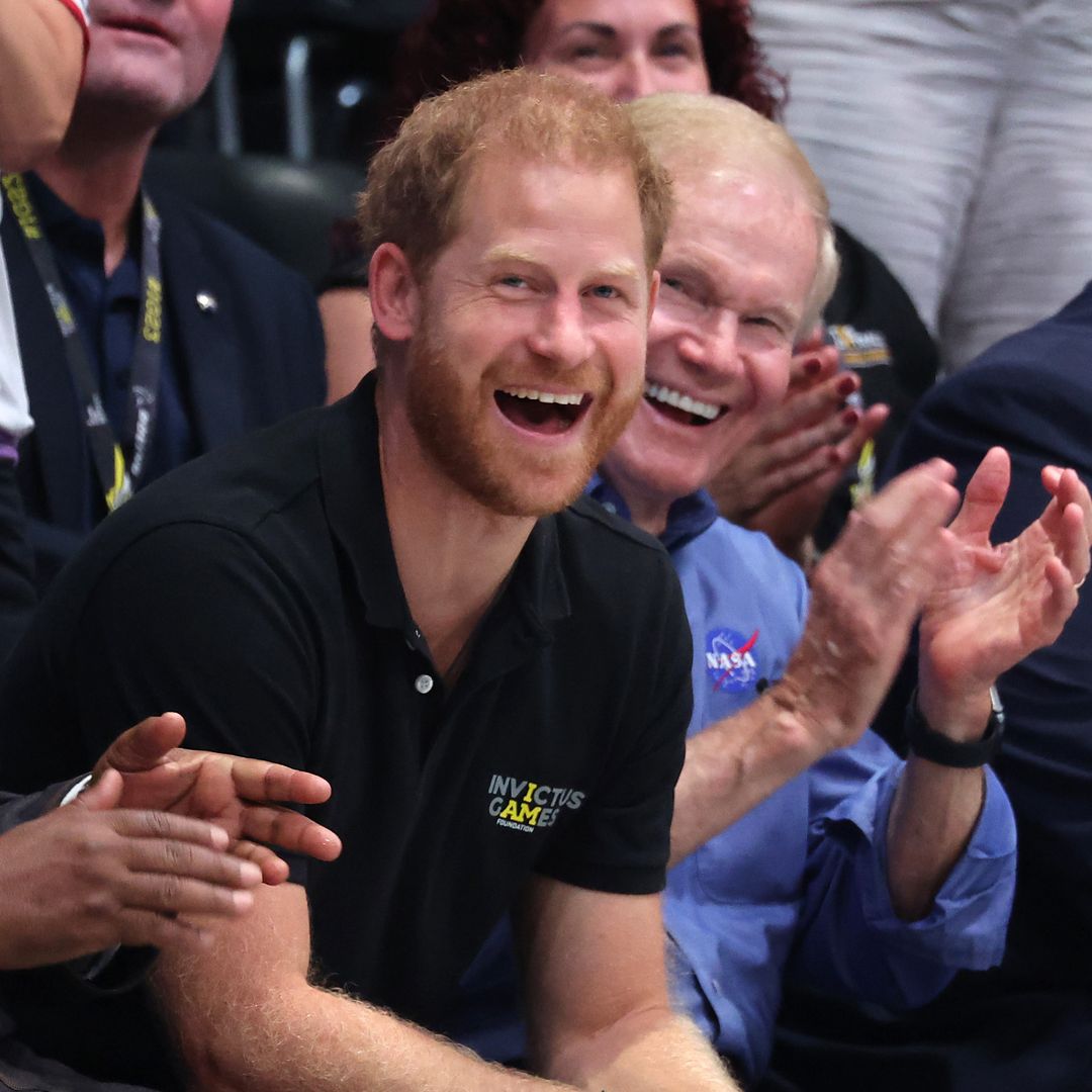 Prince Harry shows his playful side as he poses in 'stolen' pink sunglasses at Invictus Games