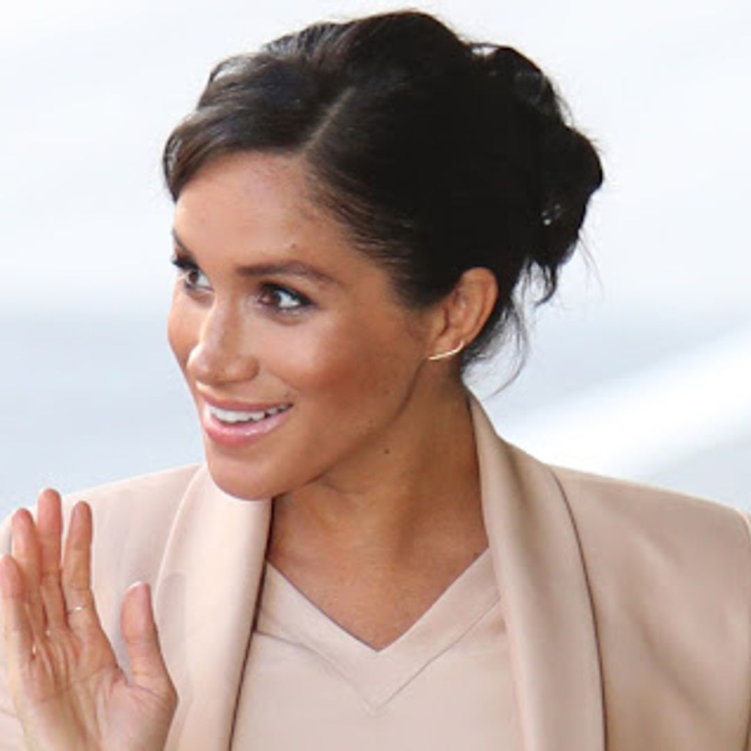 Meghan Markle is radiant in blush pink at the National Theatre - and we love her unique clutch!