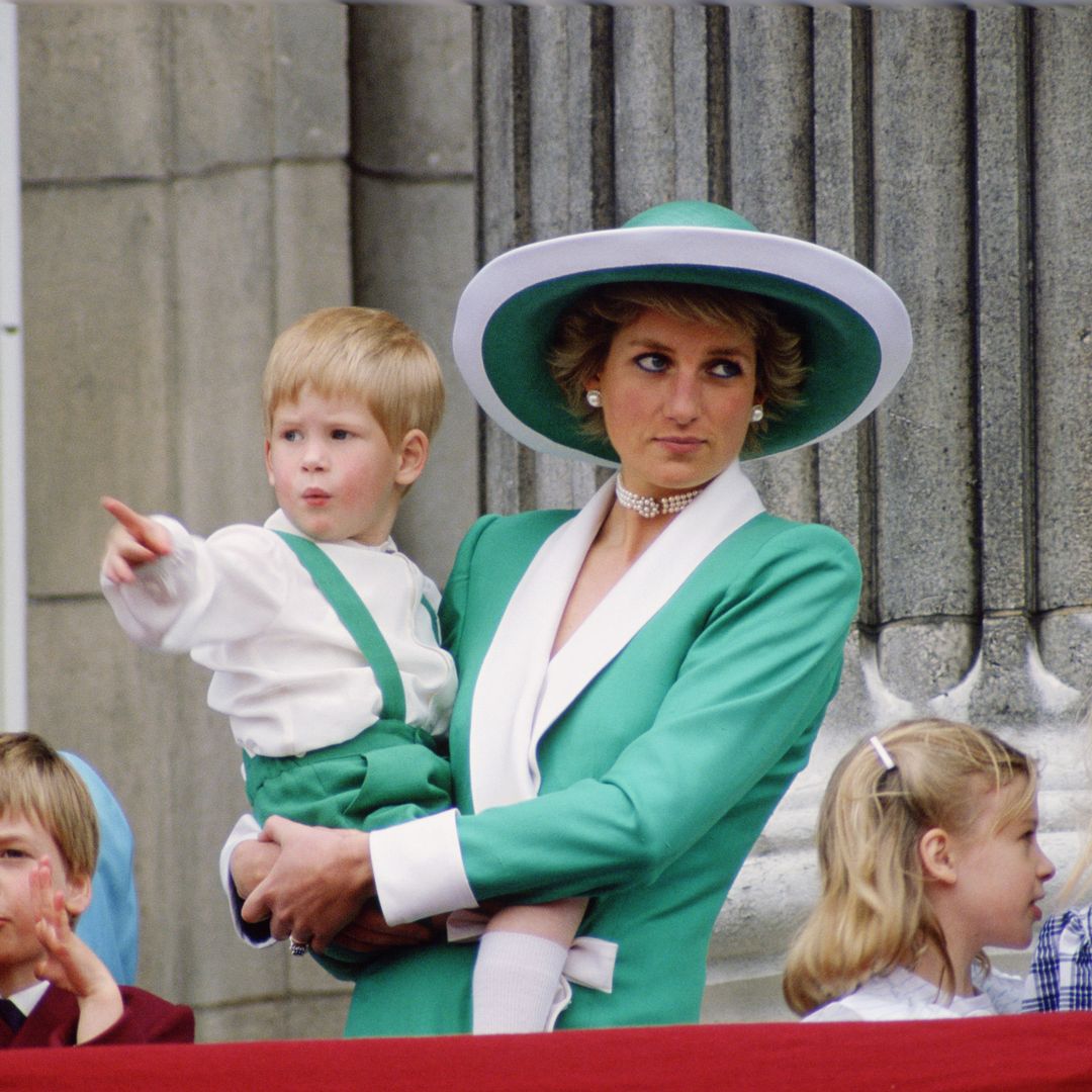 Diana, Princess of Wales, holding a young Prince Harry in her arms as she watches Trooping the Colour with Prince William, Lady Rose Windsor, Lady Davina Windsor and Princess Margaret from the balcony of Buckingham Palace  (Photo by Tim Graham Photo Library via Getty Images)