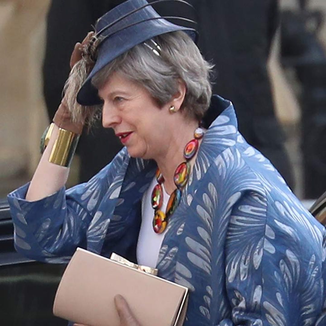 Breezy not Brexit! Theresa May battles with her hat as she mingles with the royal family at the CommonWealth