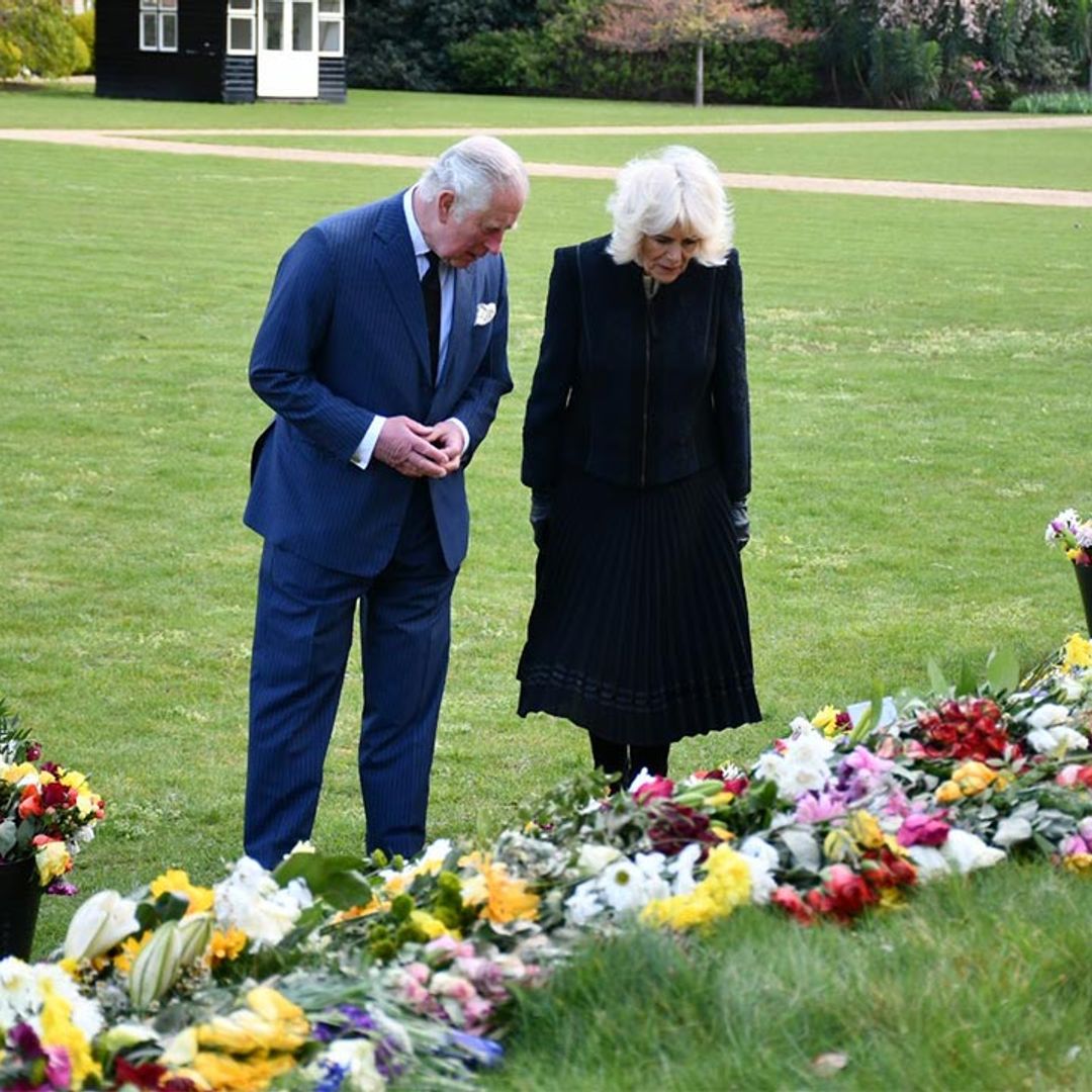 Prince Charles and Camilla visibly moved as they view floral tributes left for Prince Philip