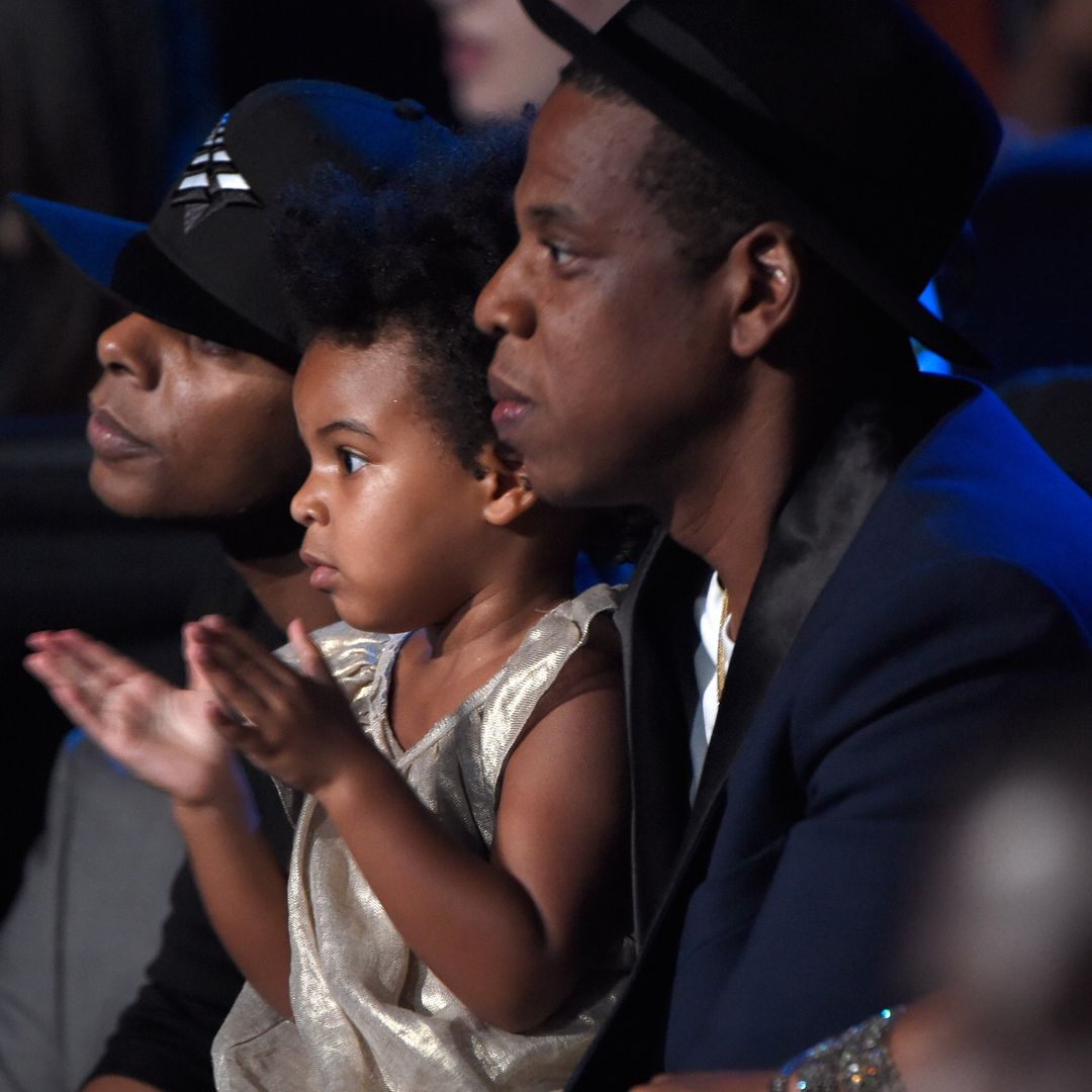 Blue Ivy clapping while sat next to her dad Jay-Z