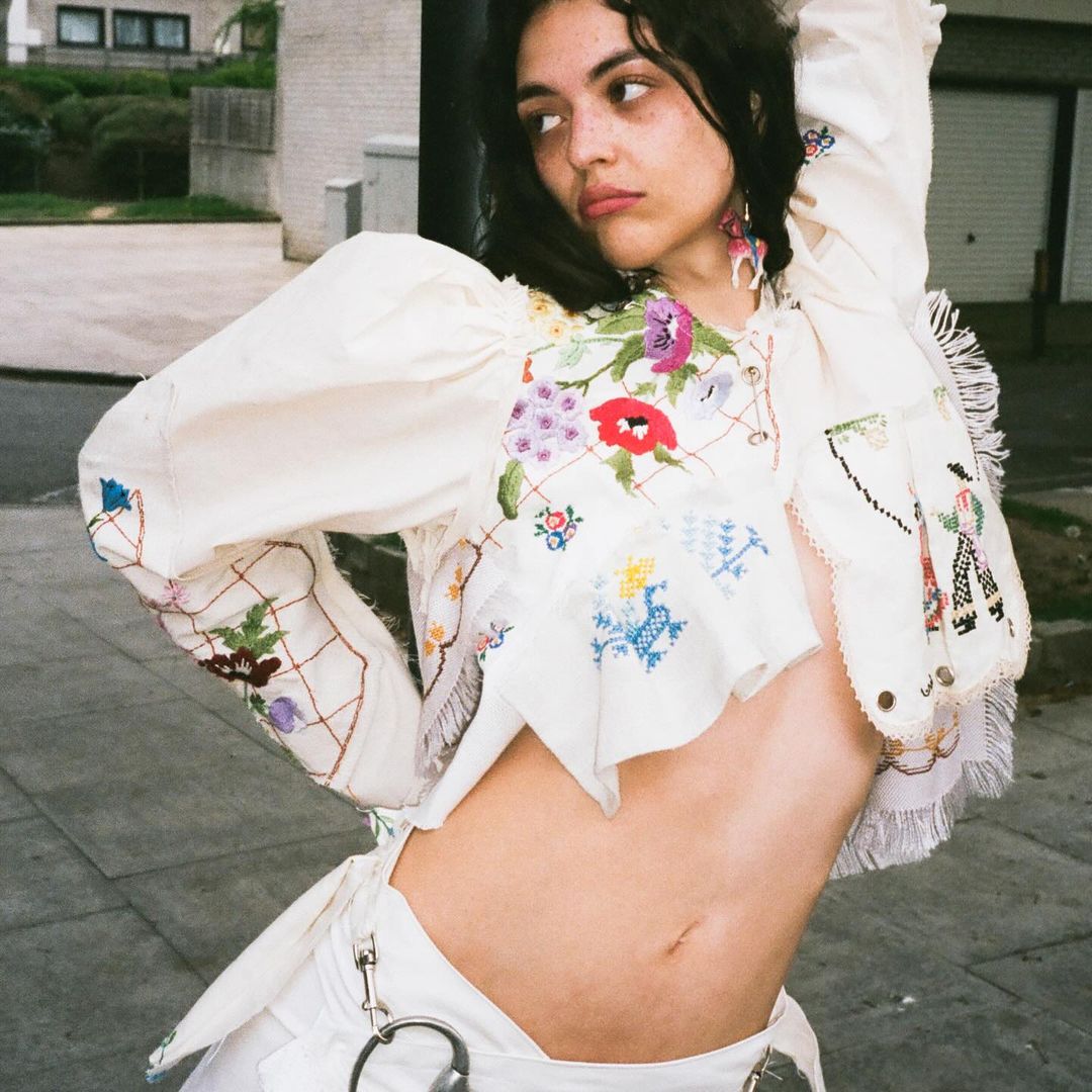 model in white embroidered outfit