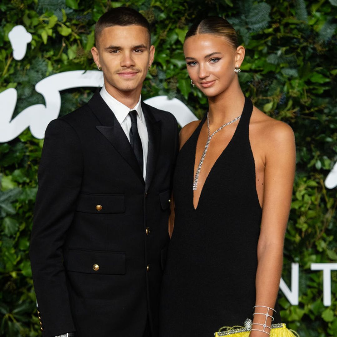Mia Regan and Romeo Beckham in a black suit and black dress 