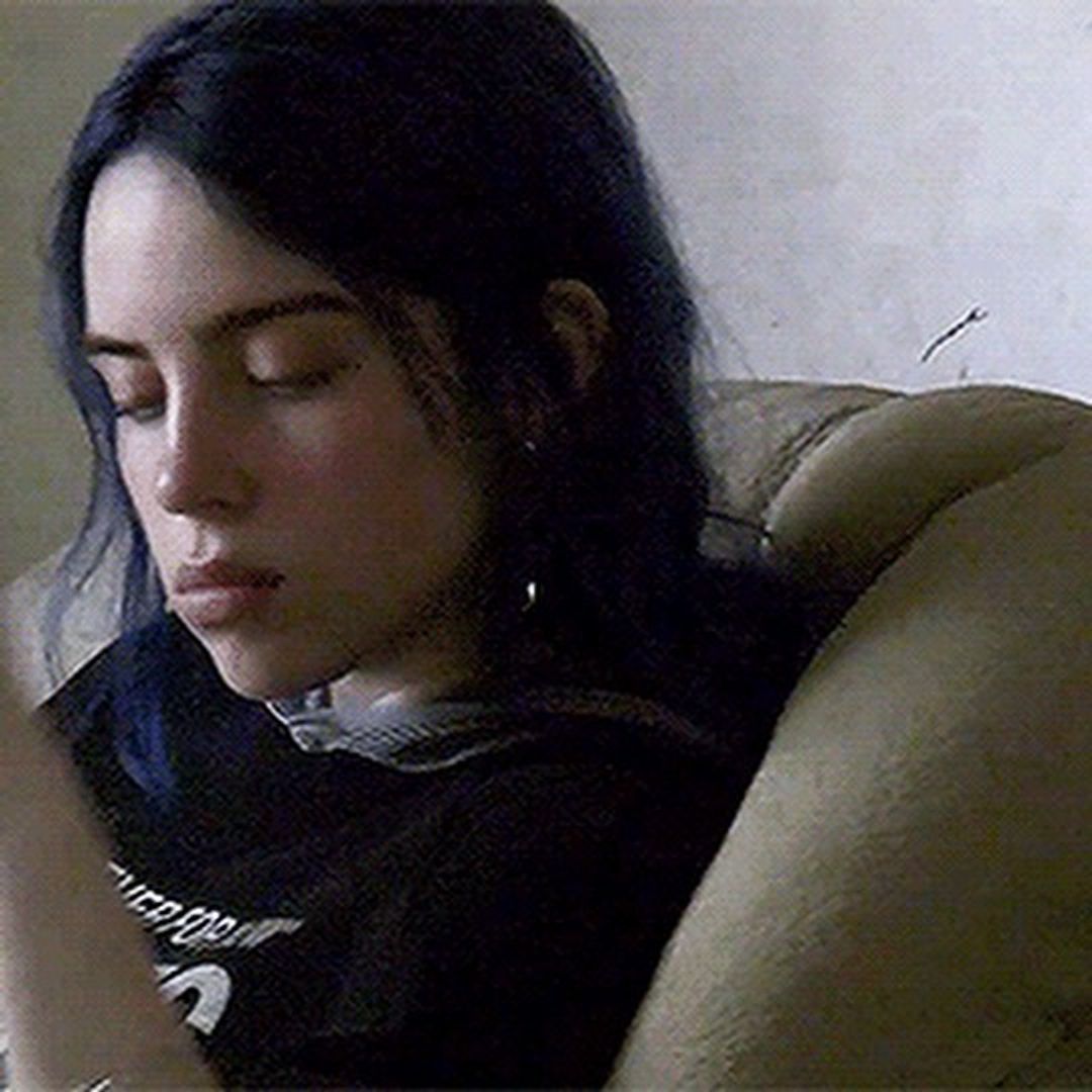 Billie Eilish in a blurred photo from her youth, she has dark blue hair