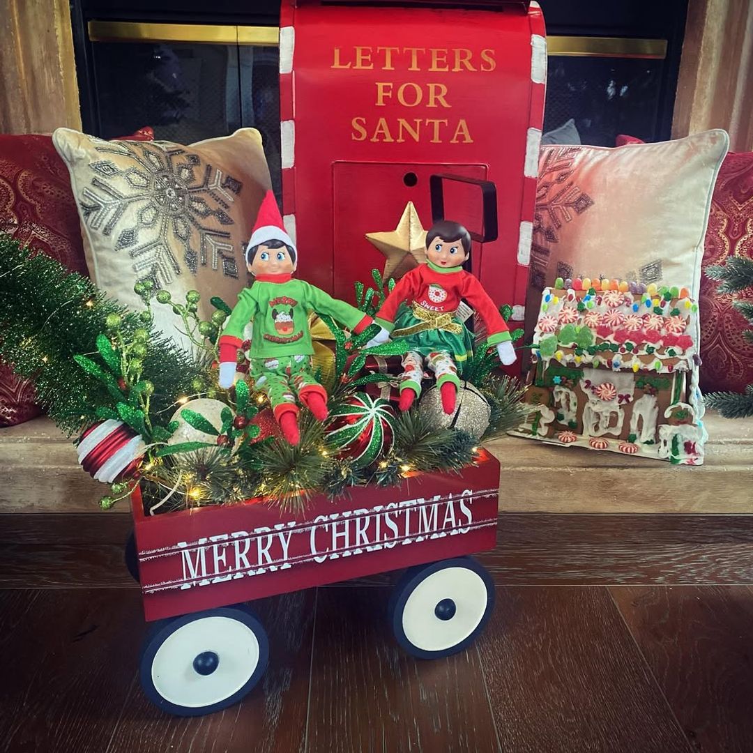 Lacey Chabert's Christmas vignette with elves and a wagon beside cushions, shared on Instagram