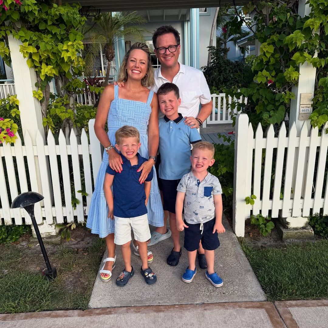 Dylan Dreyer and Brian Fichera pose for a photo beside a white picket fence with their three sons, shared on Instagram