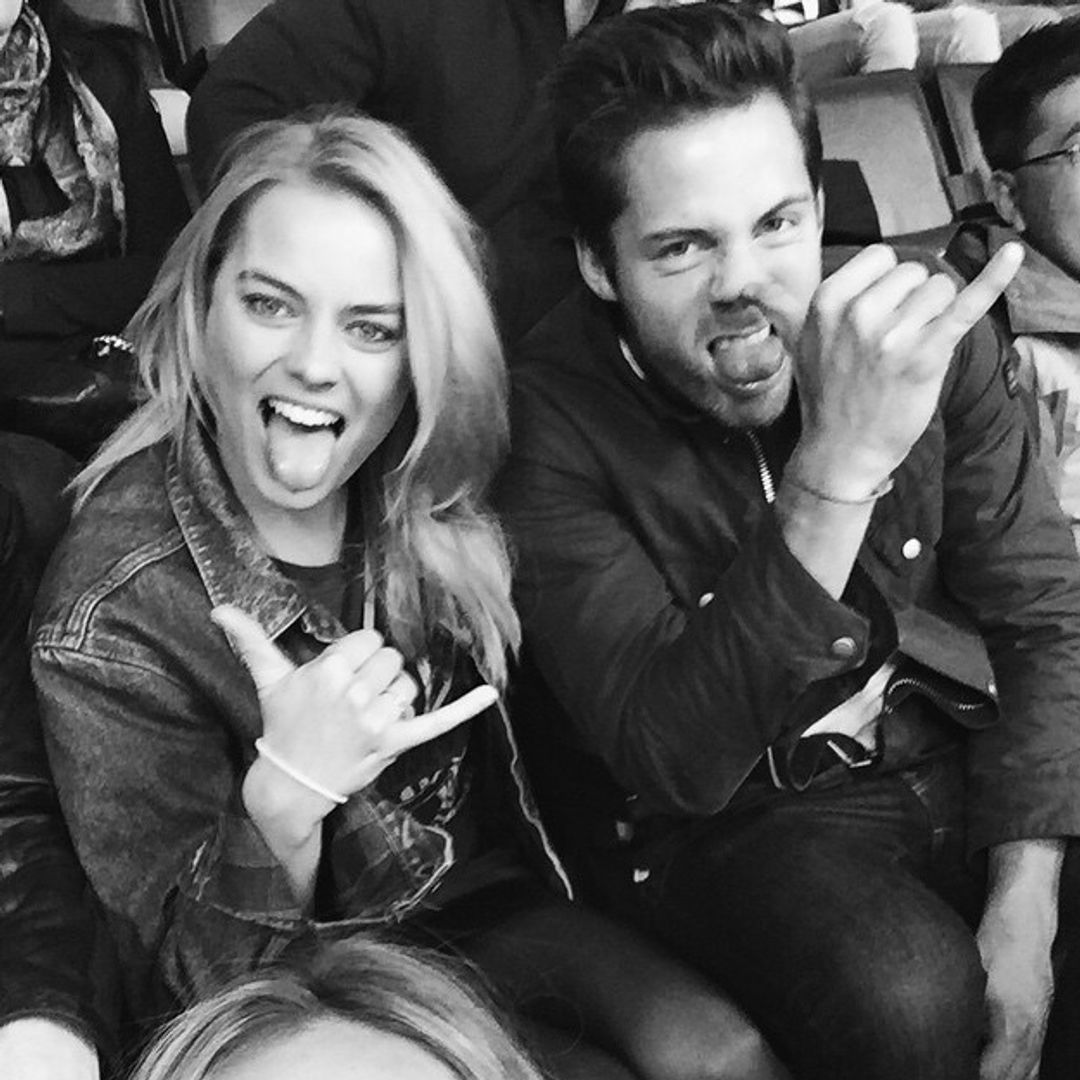 Margot Robbie and Tom Ackerley making faces in a candid black and white photo