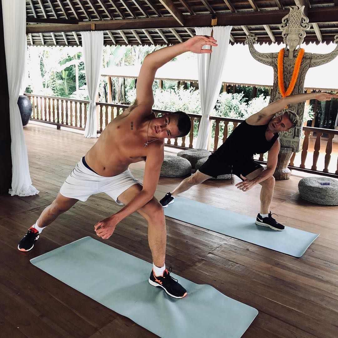 father and son doing yoga stretch