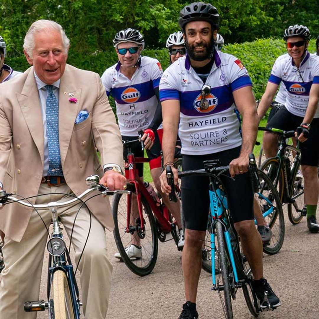 Prince Charles get the giggles as he rides a bicycle near his country home