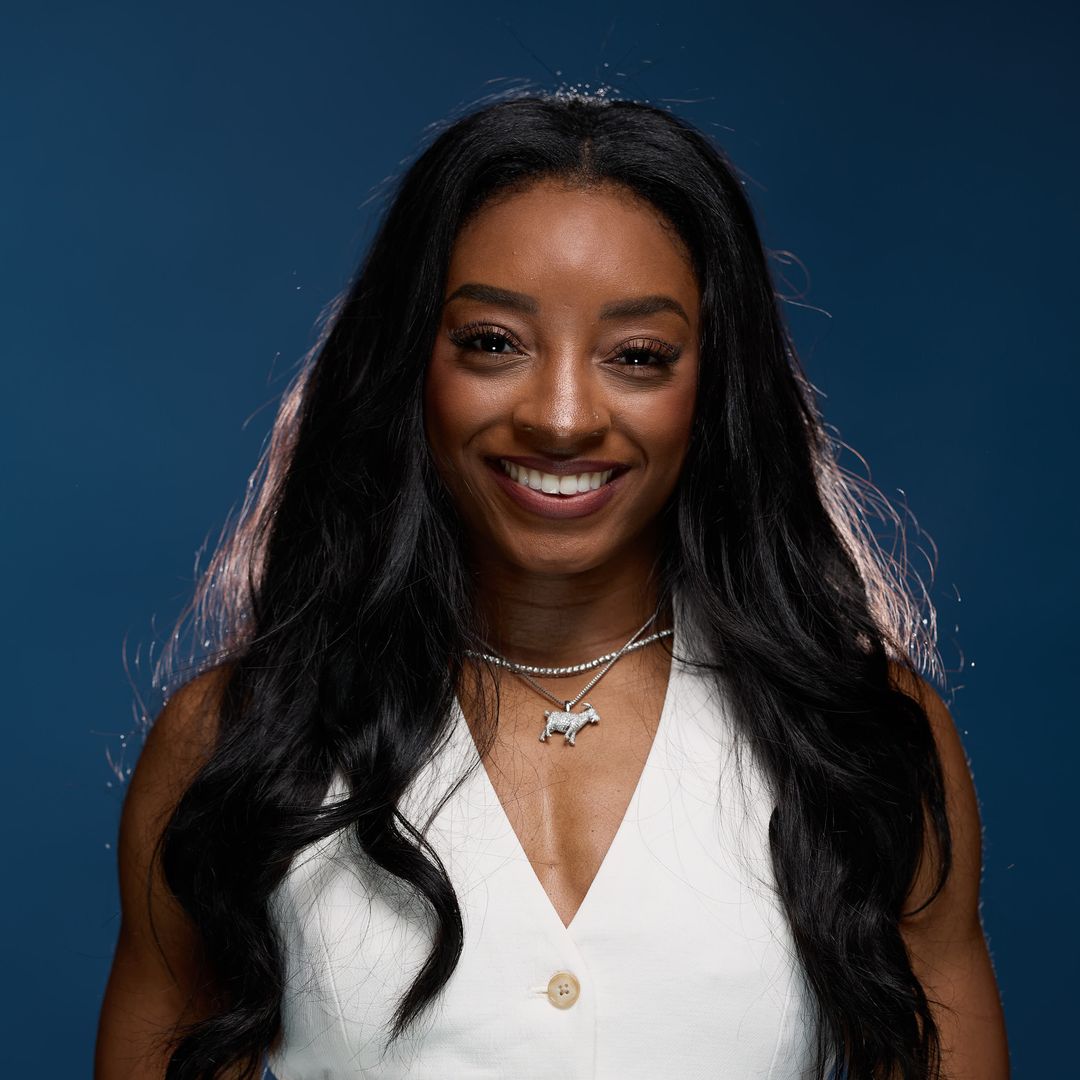 Simone Biles stuns in white mini dress as she poses with all 11 Olympic medals