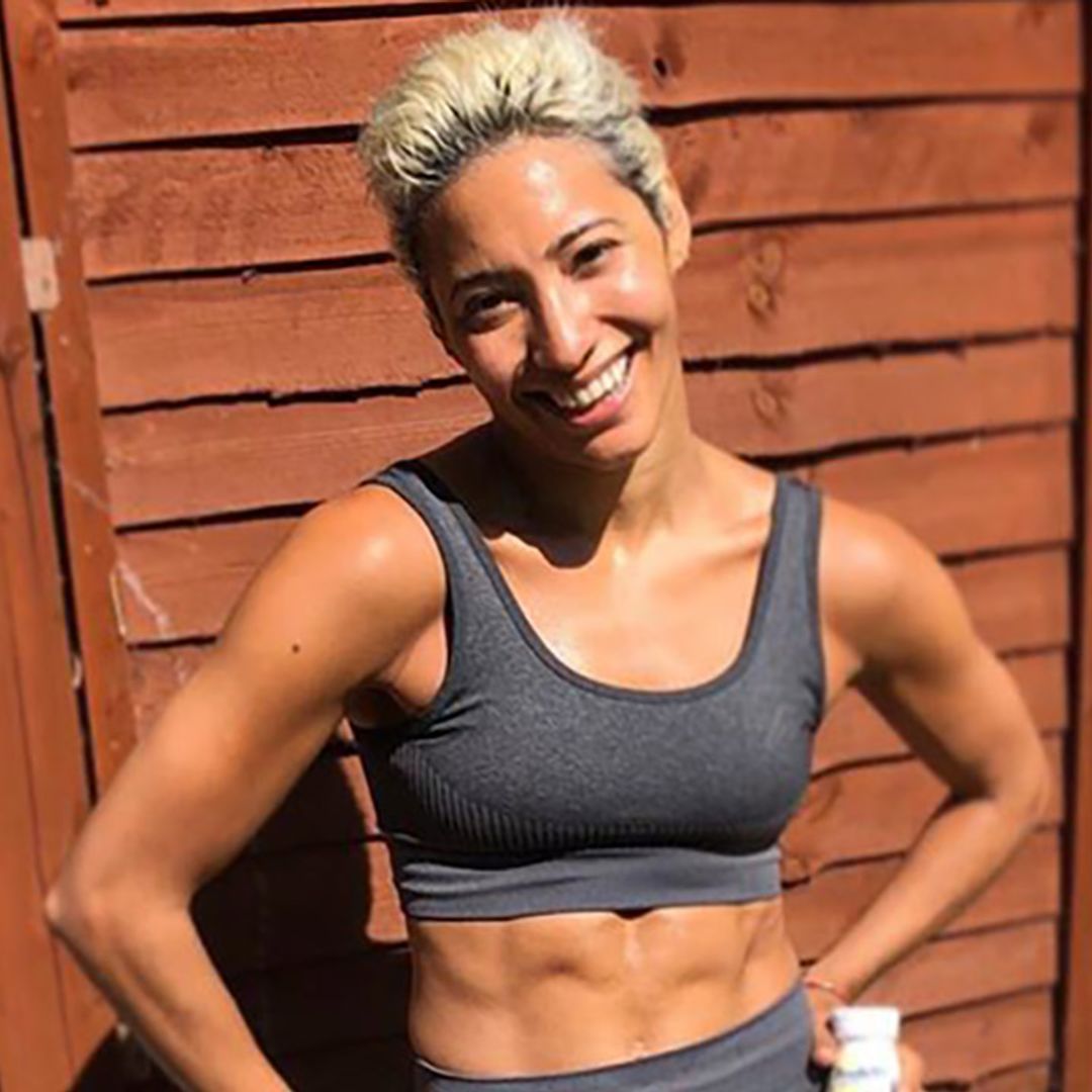 Karen Hauer shows off washboard abs as she poses in black lacy bikini