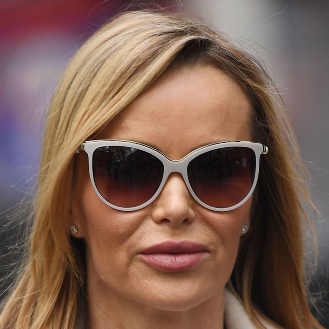Amanda Holden strikes a pose in leather mini skirt and knee-high boots