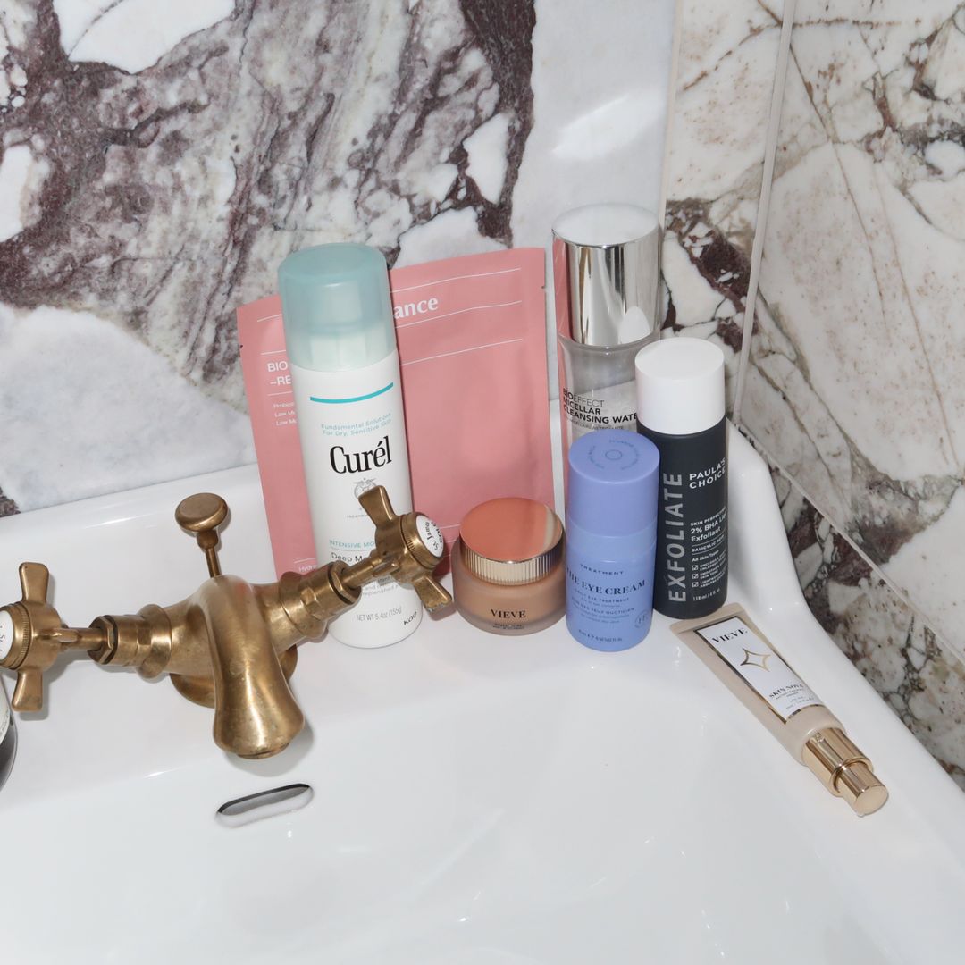 Skincare products sitting on top of a bathroom sink