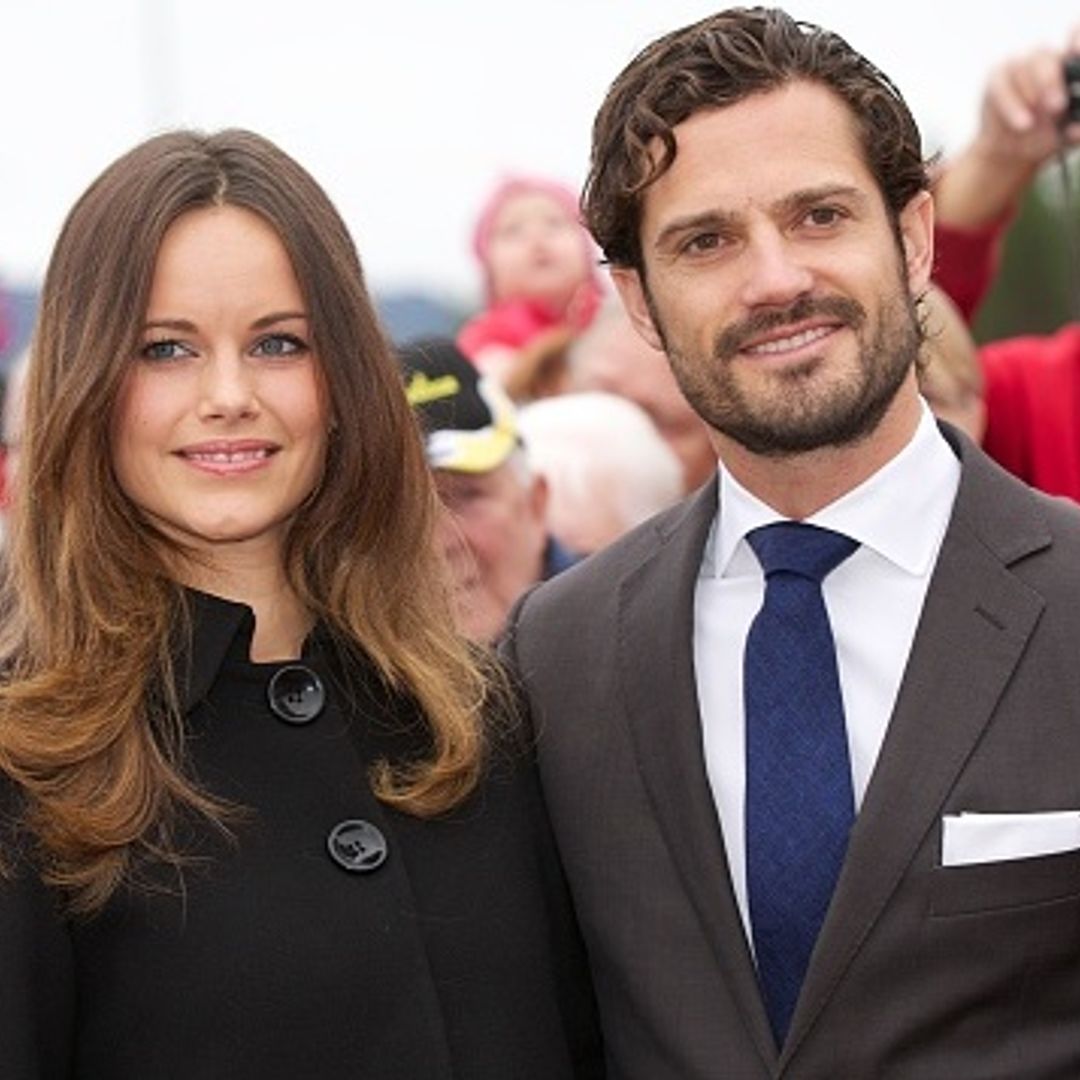 Princess Sofia and Prince Carl Philip of Sweden pose with a fan while baby shopping