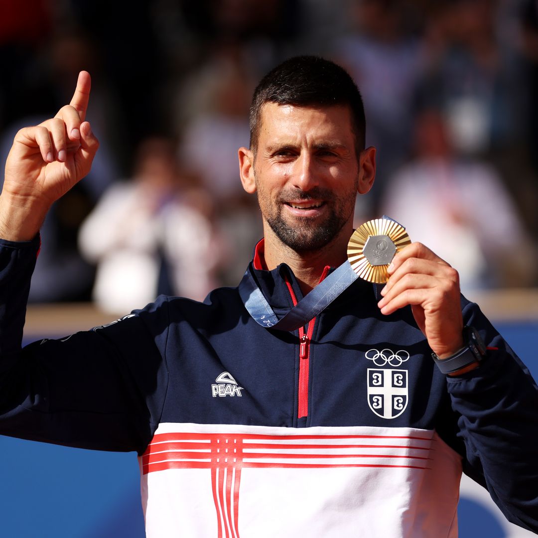 Gold medalist Novak Djokovic of Team Serbia celebrates on the podium during the Tennis Men's Singles medal ceremony after the Tennis Men's Singles Gold medal match on day nine of the Olympic Games Paris 2024 at Roland Garros on August 04, 2024 in Paris, France.