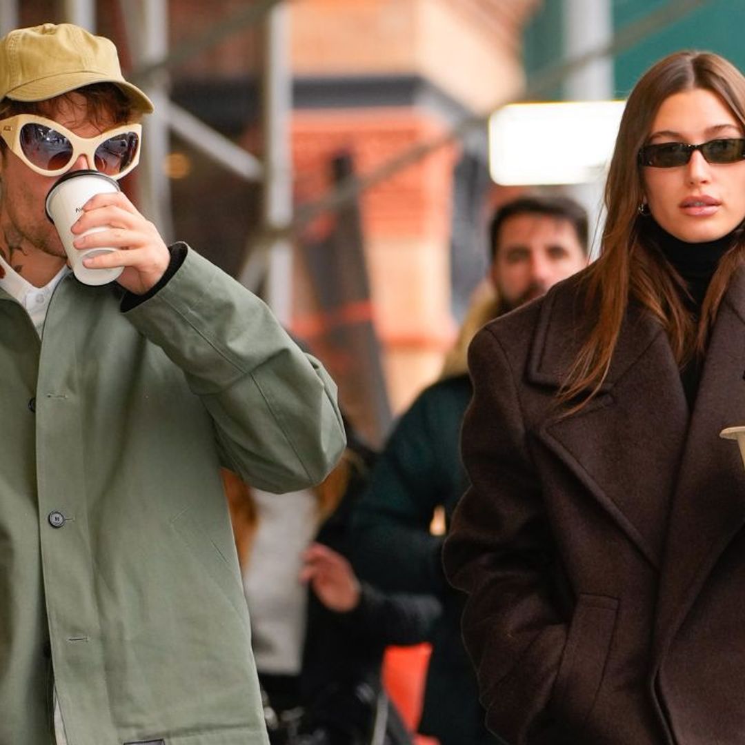 Hailey Baldwin in beige oversized jacket and black sneakers in