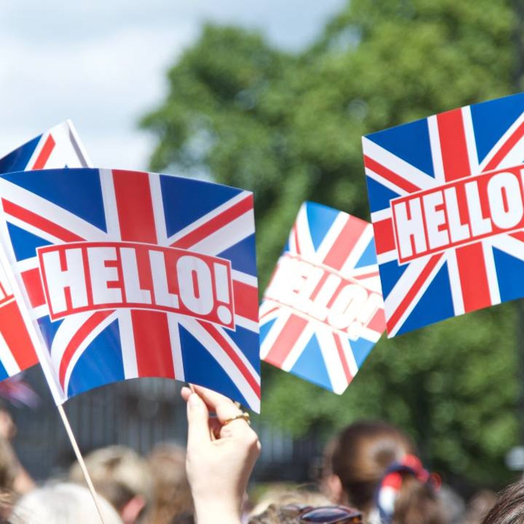 Royal fans seen waving HELLO! flags and cheering on the Queen amid Jubilee celebrations