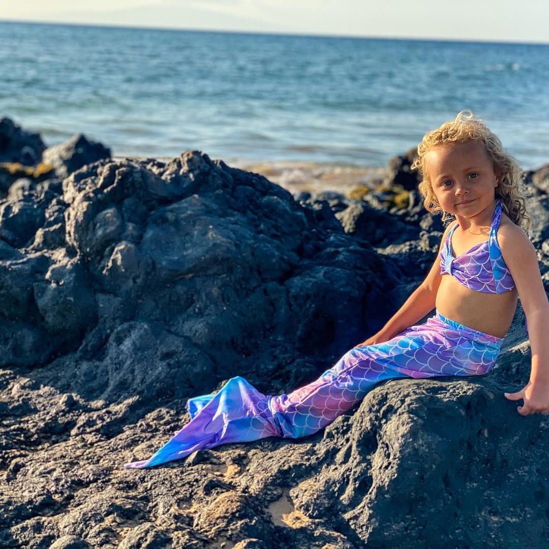 Alfonson Ribeiro's daughter Ava poses for in a mermaid costume on a rock by the beach, shared on Instagram