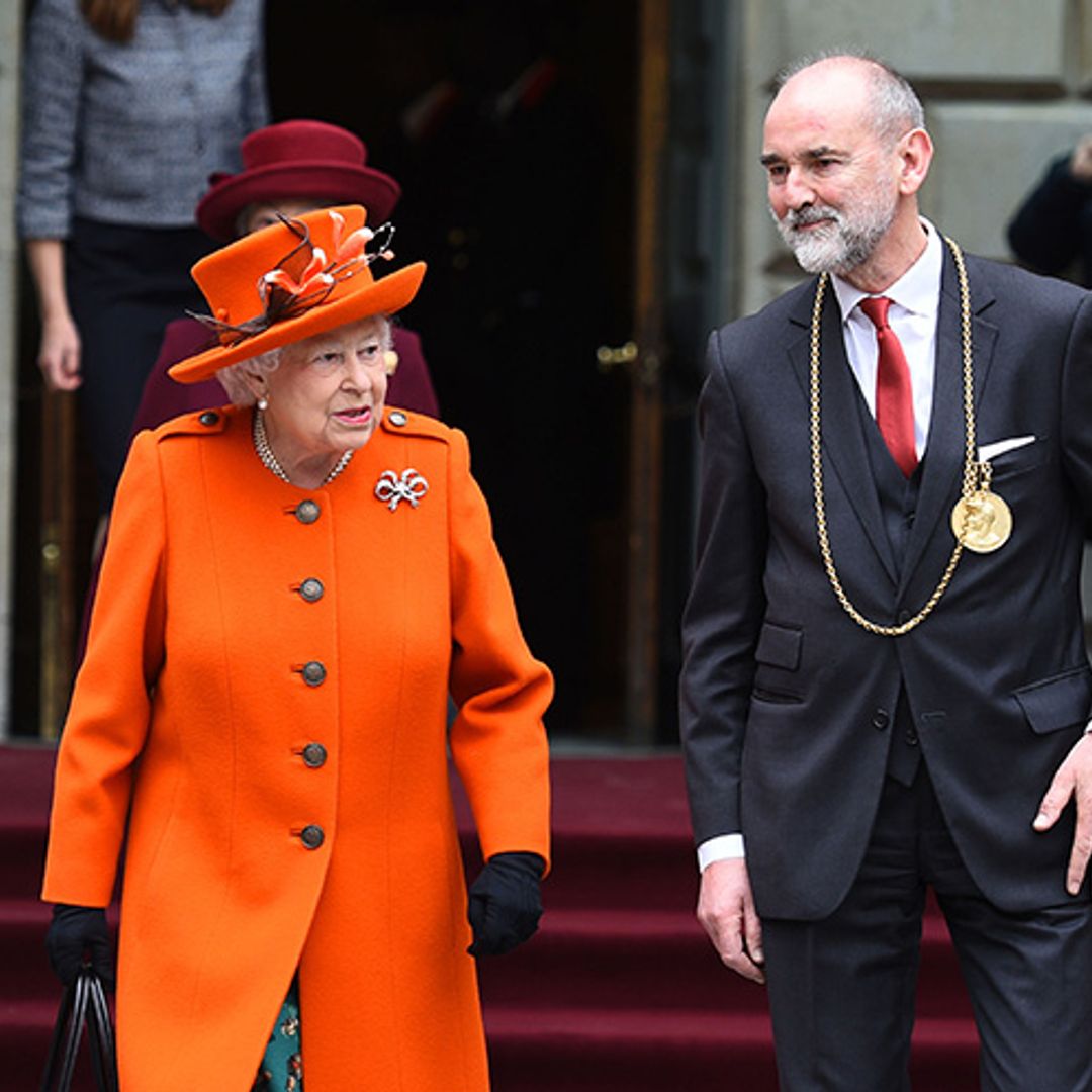 The Queen marks the first day of spring in super-bright orange outfit