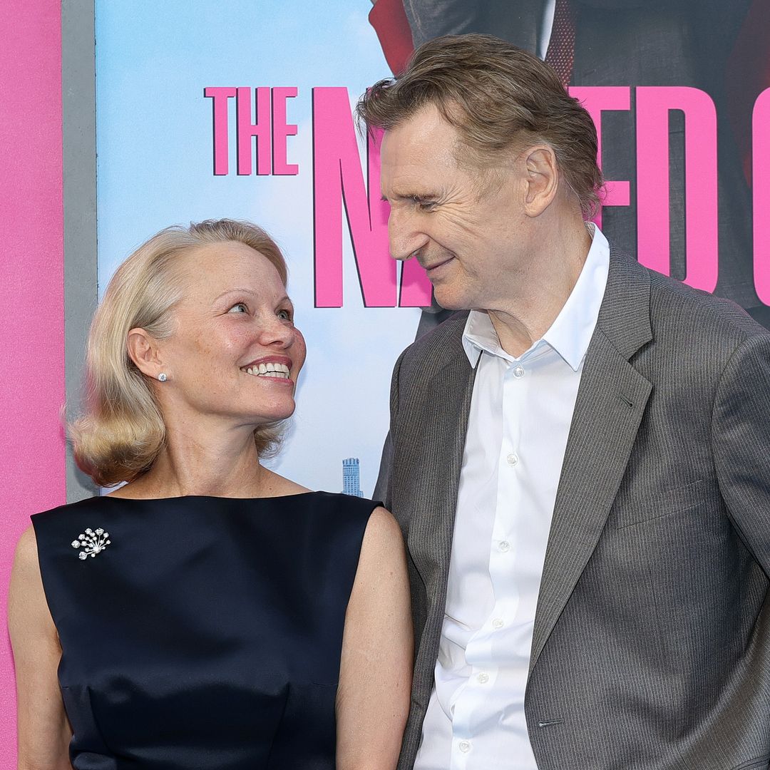 Liam Neeson plants a kiss on Pamela Anderson in adorable moment