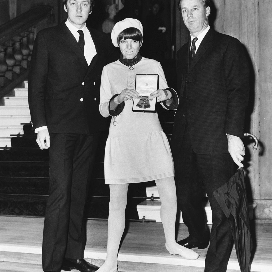 The fashion designer Mary Quant at Buckingham Palace with her husband Alexander Plunkett-Greene (l) and Archie McNair, the Chairman of Mary Quant Fashions. She displays her O.B.E. medal after being presented with it by the Queen, 1966. (Photo by Â© Hulton