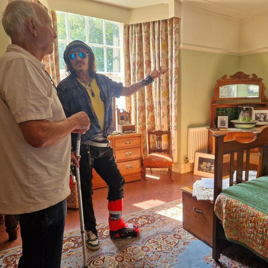Johnny being shown around the room where Dylan Thomas was born