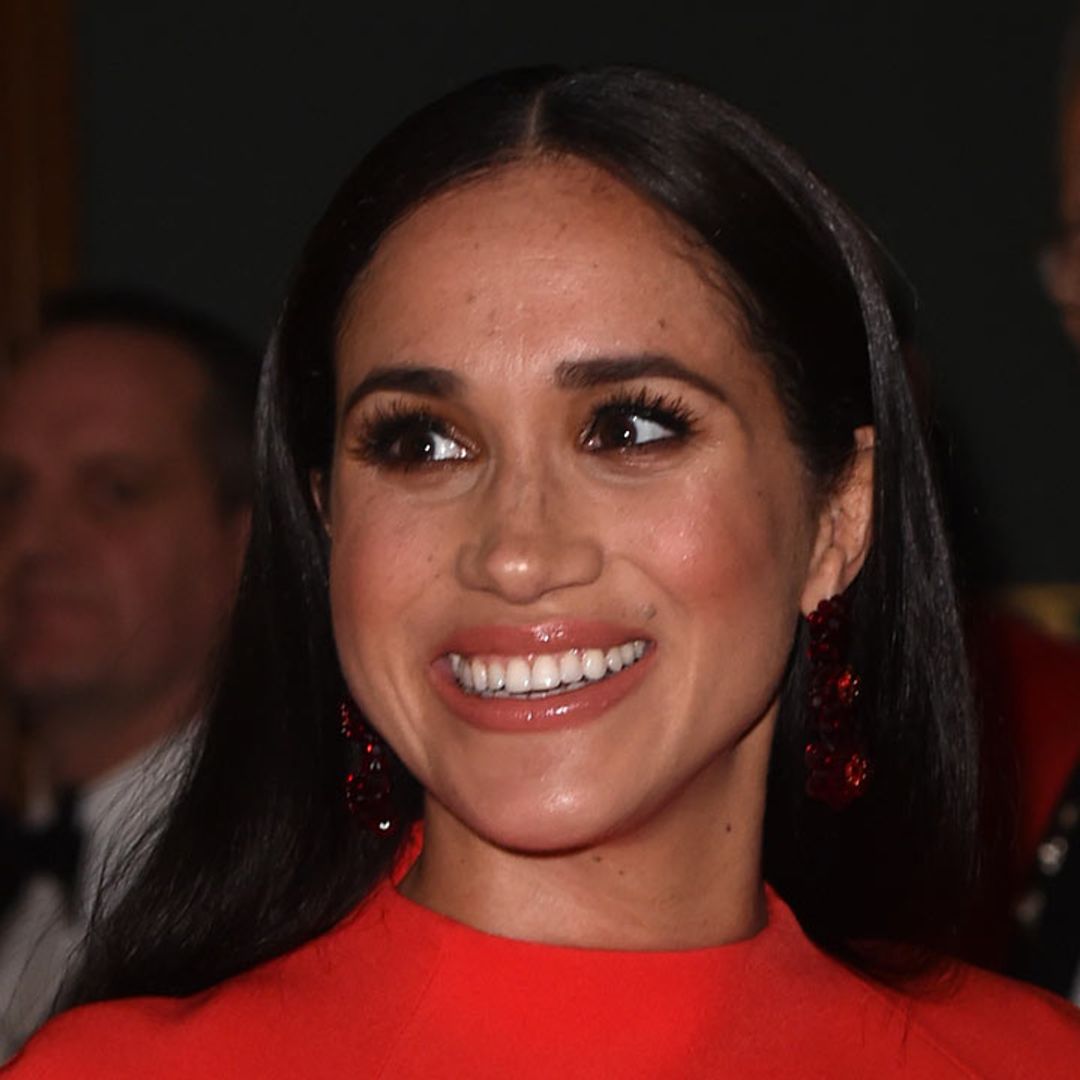Meghan Markle looks sublime in slinky red ensemble for poignant Manchester event