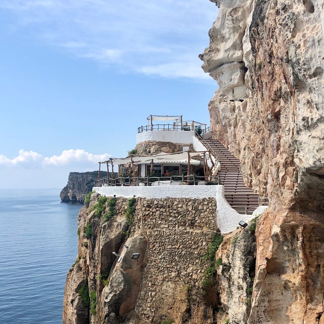 exterior shot of Cova d'en Xoroi, a bar set in a cliff in Menorca