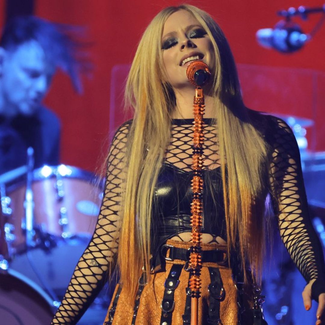 Avril Lavigne shows off tiny waist in mini skirt and fishnet tights -  sparks reaction | HELLO!
