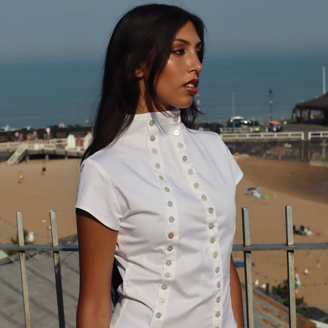 model in white button shirt