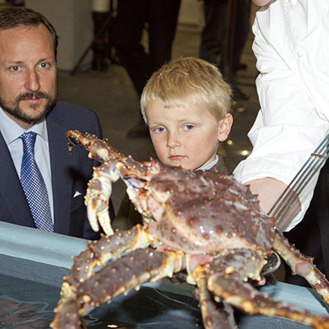 A kiss for my little prince: Haakon calms his boisterous son with affection