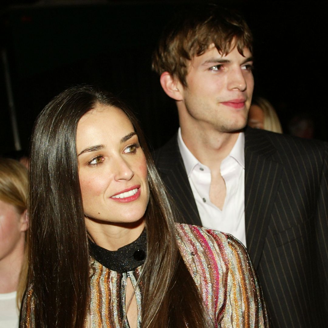 Ashton Kutcher and Demi Moore looking to the right