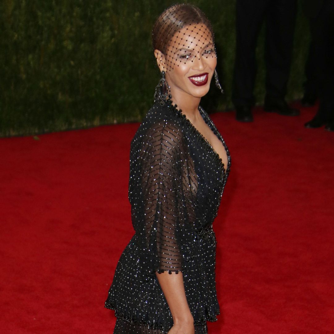 Beyoncé models plunging wedding guest dress and thigh-length curls