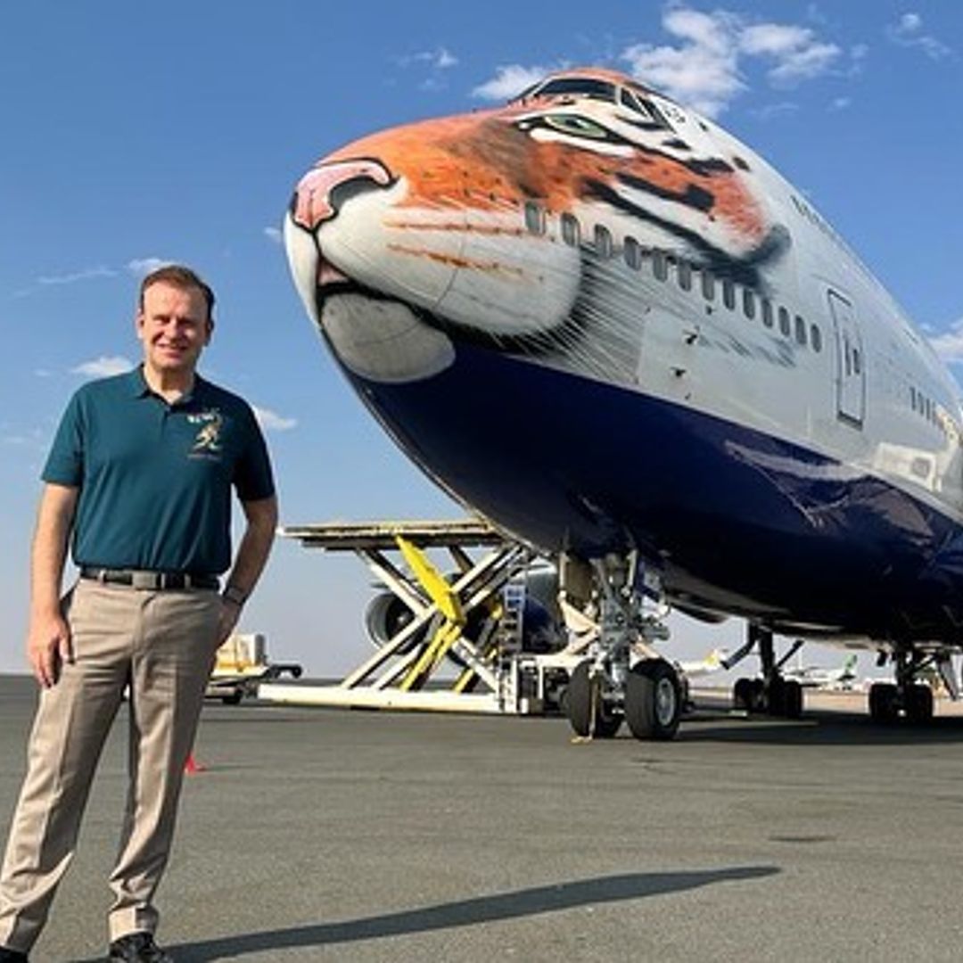 Harding stood in front of a jet with a big cat's face painted on it