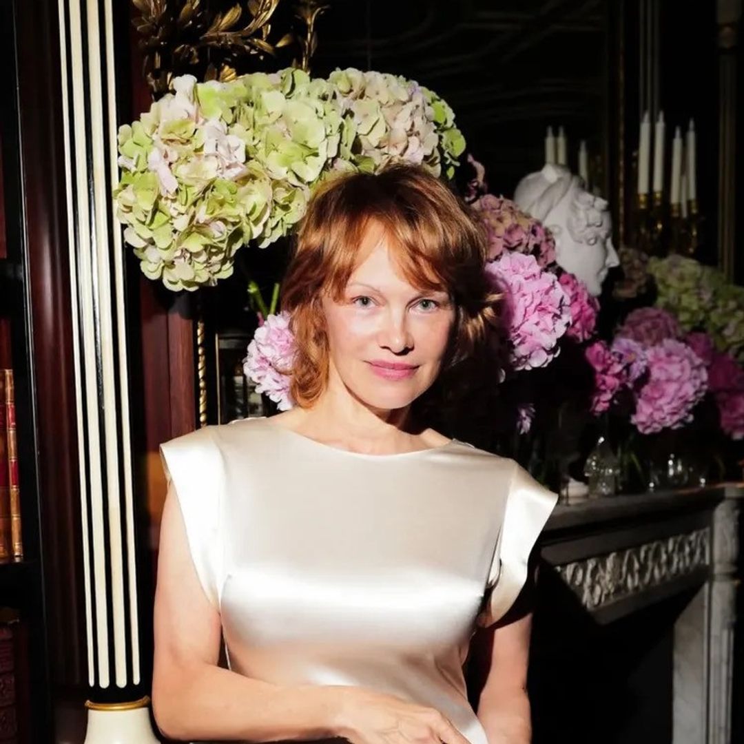 Pamela Anderson's new red hair playfully matches her sky-high stilettos perfectly