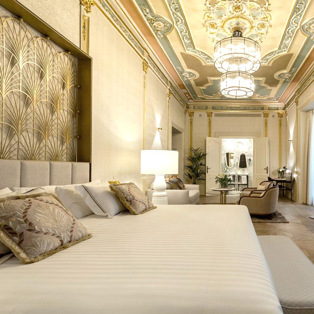 bedroom suite at palacio vallier with large bed and chandelier on ceiling
