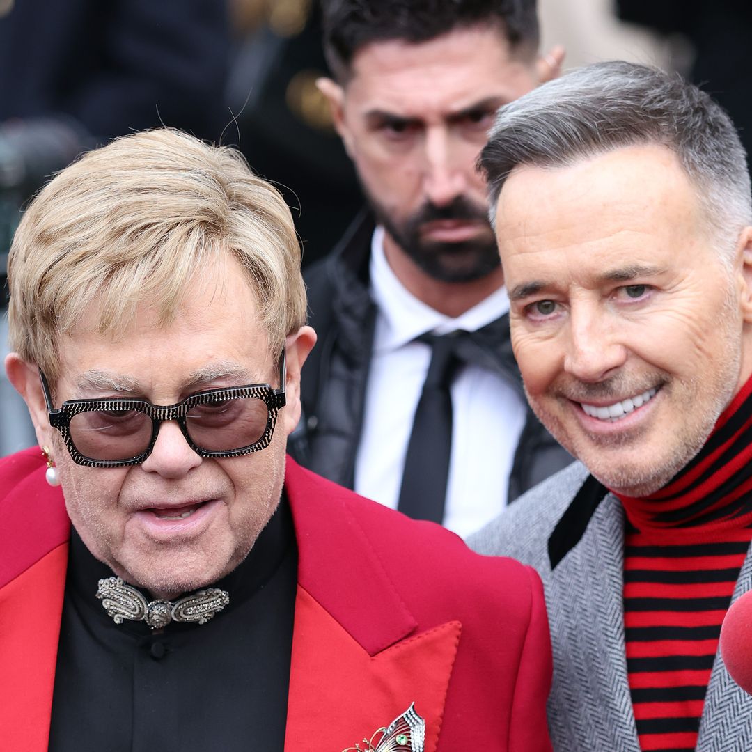 Elton John clutches 'custom' £1.4k Valentino man bag as he's supported by David Furnish in Paris