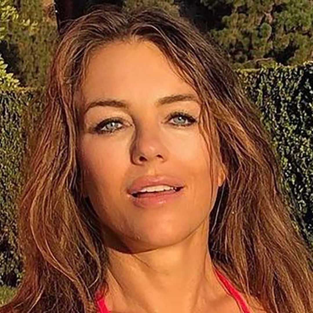 Elizabeth Hurley poses in her underwear and just a T-shirt as she enters health clinic
