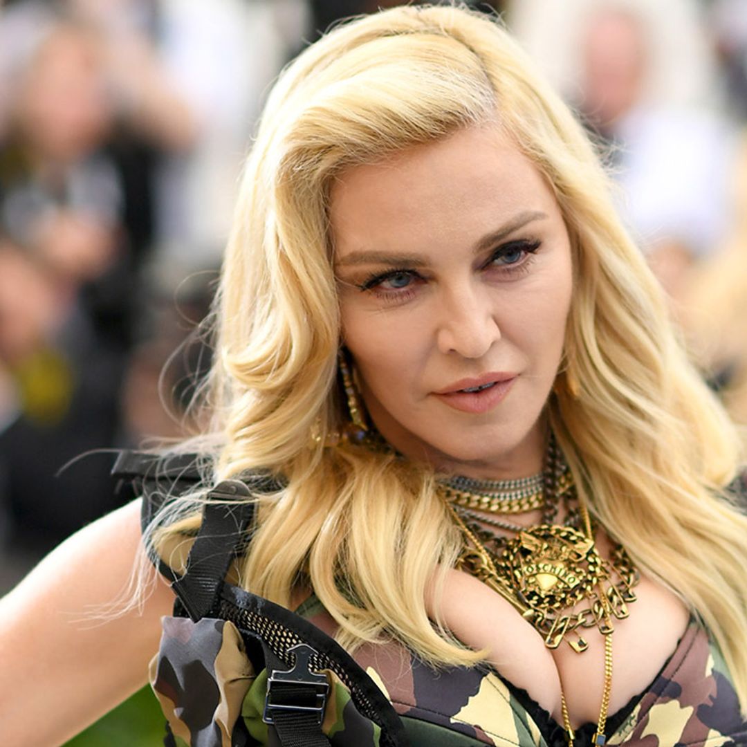 Madonna poses up a storm in a corset and ripped jeans in sensational photo