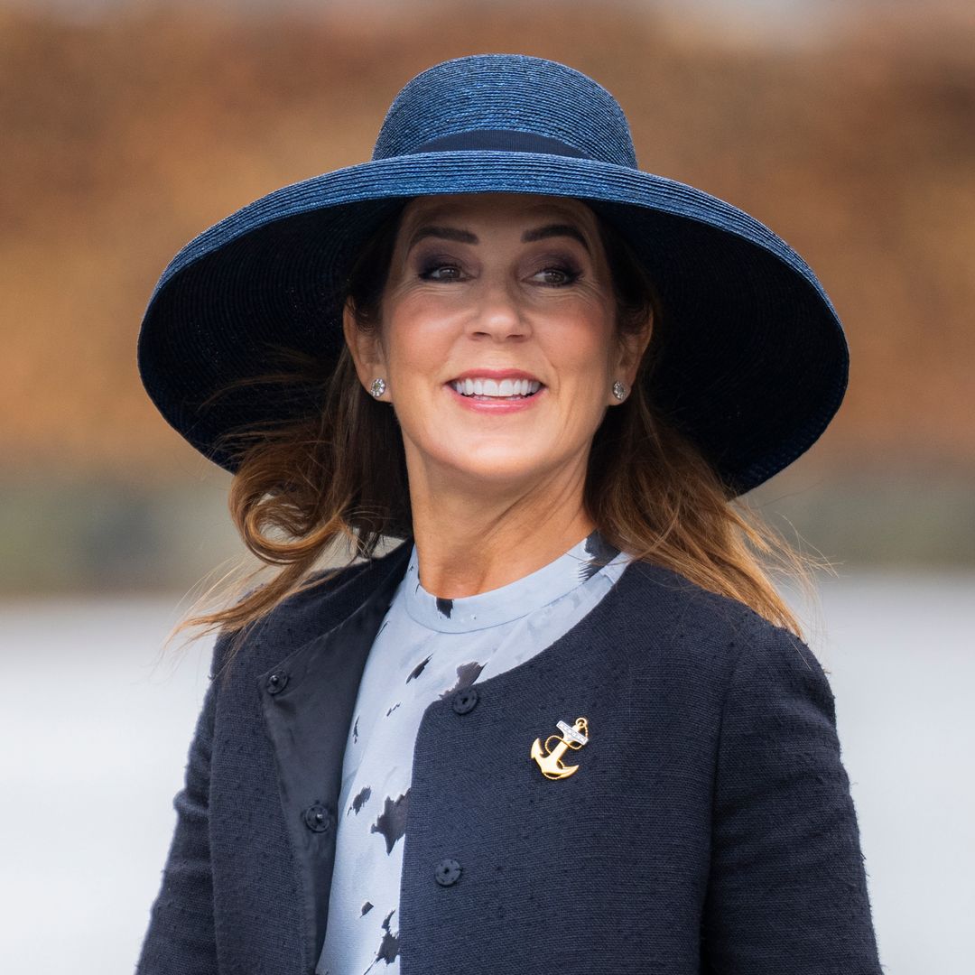 Queen Mary channels Audrey Hepburn in tailored skirt and most enormous hat