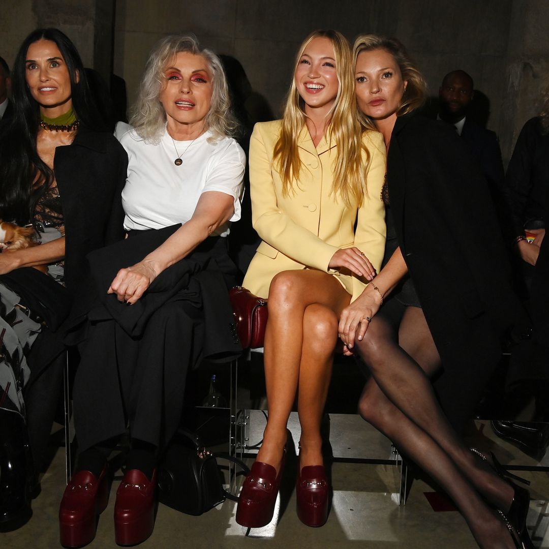 Lila Moss wearing a yellow co-ord at Gucci's Cruise show with Kate Moss, Debbie Harry and Demi Moore 