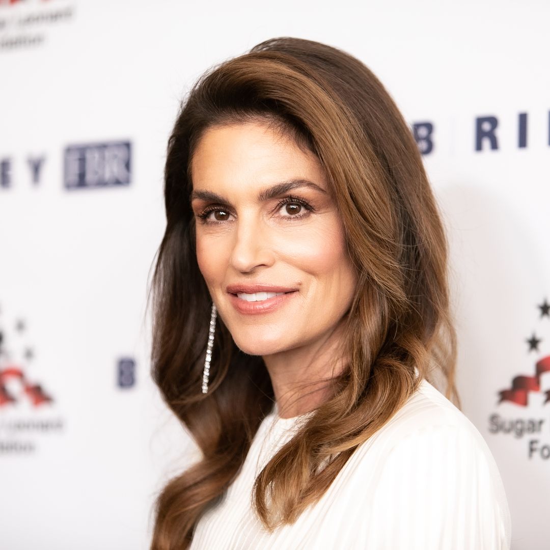 Cindy Crawford, 57, sparkles in glamorous mini dress as she cuddles up to husband
